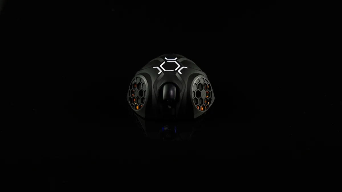 Close-up of a RoboSoccer robot showing omni wheels and grab-and-kick mechanism